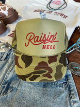 Load image into Gallery viewer, Raisin&#39; Hell Green Camo Trucker Hat
